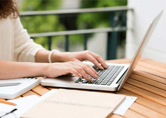Author writing a manuscript on a laptop
